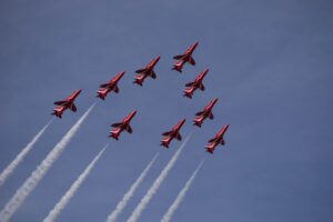 The red arrows flying in a triangular formation against a blue sky. Intended to reflect the power of lawyers in a team working together following training.