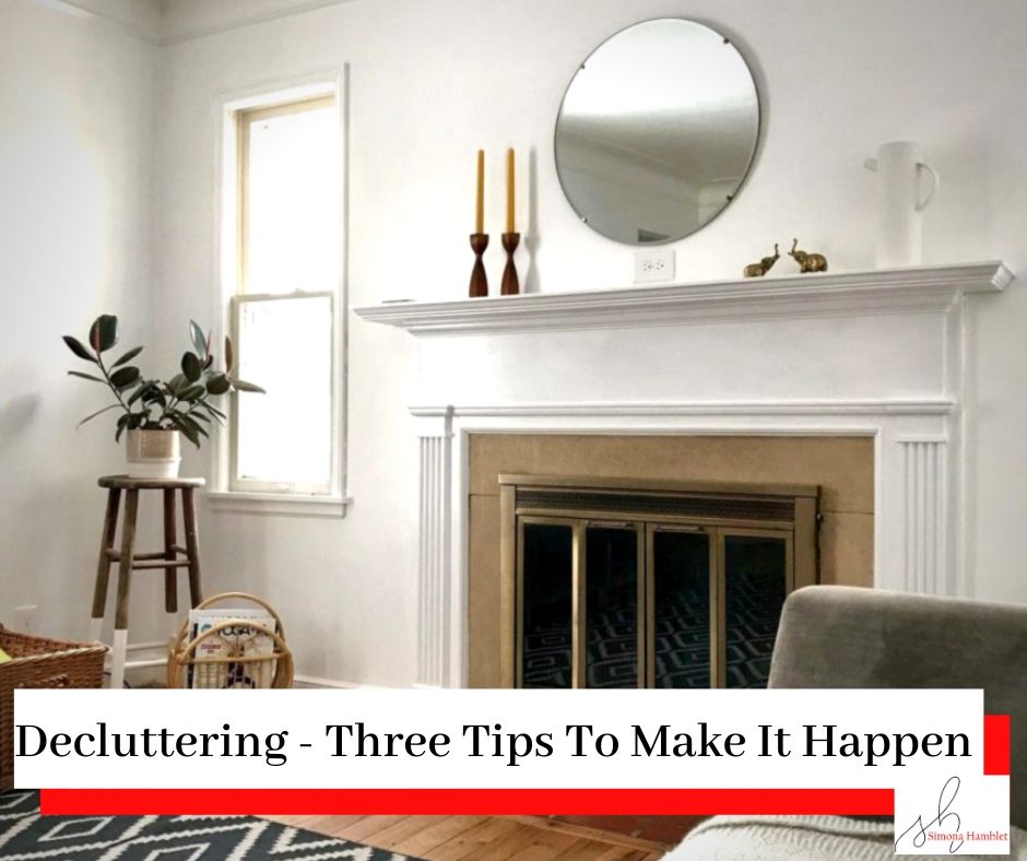 A white, clean, clear, and tidy lounge with a fireplace and a mirror with the title Decluttering - Three Tips To Make It Happen