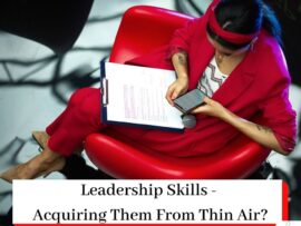 Woman in red sat in a chair with a clipboard and a mobile phone along with the article title Leadership Skills - Acquiring Them From Thin Air?